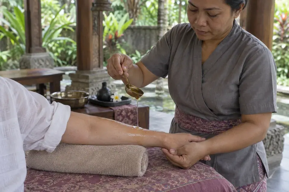 Herbal oil applied to the forearm during Ayurvedic massage