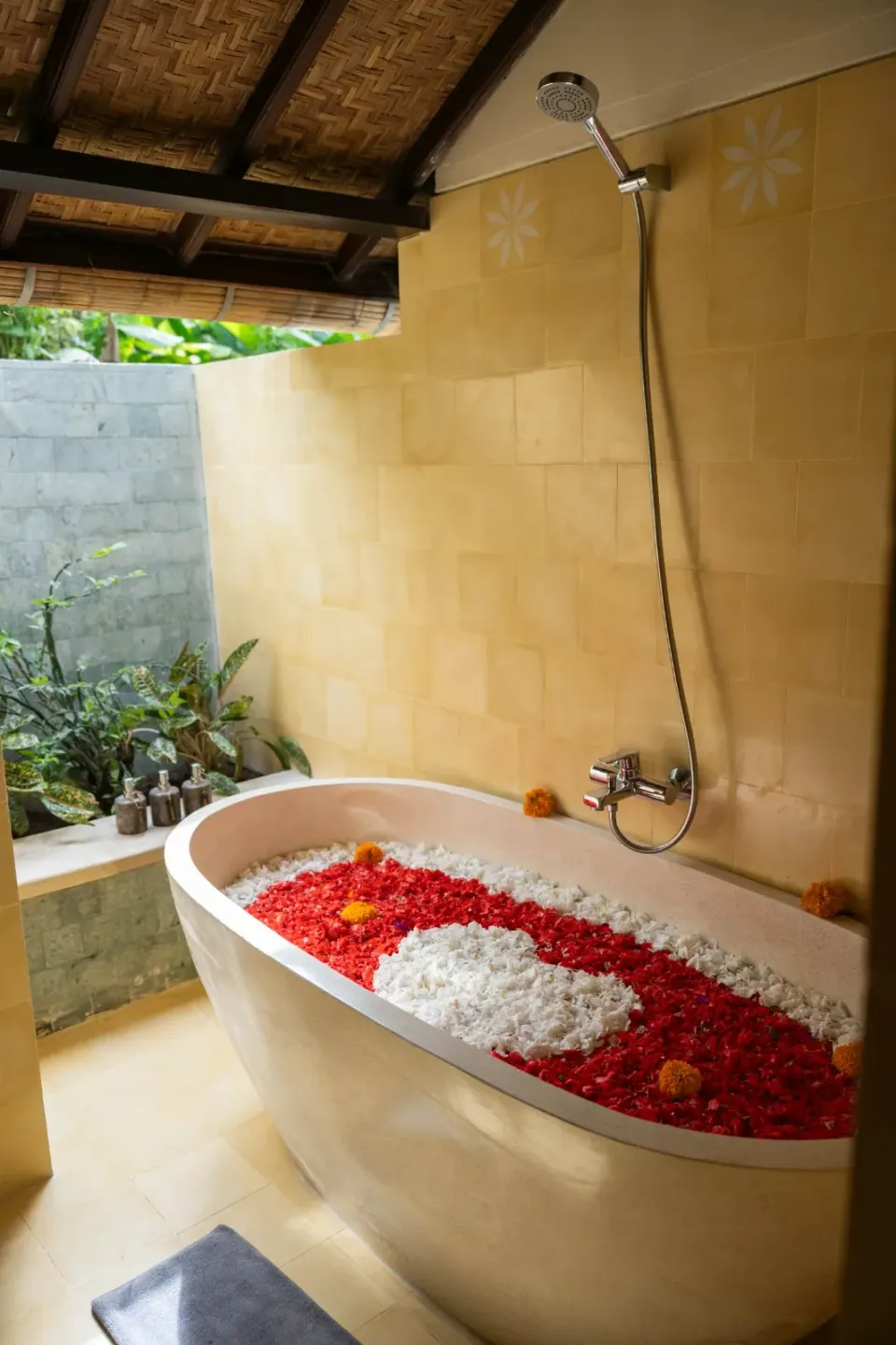 A flower-filled bath beside a garden shower