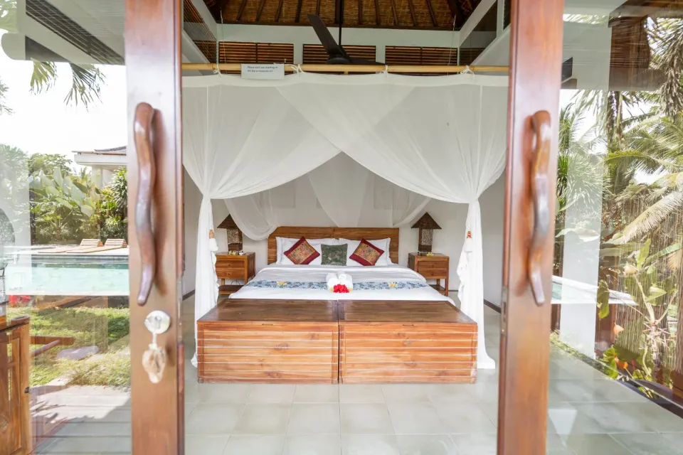 A timber bedroom viewed through its open entrance
